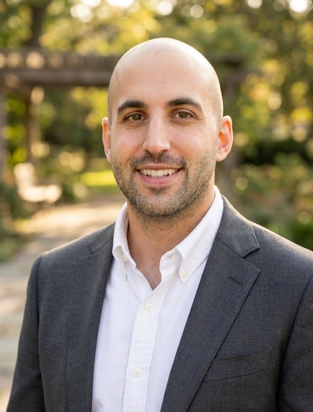 Dr. Serop Chalian smiling outdoors, wearing a suit jacket